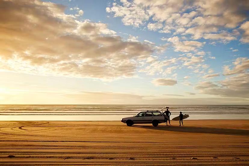 Golden sands and rolling waves make New Zealand's Ninety Mile Beach an irresistible spot to surf until sundown © Amos Chapple / Lonely Planet Images / Getty Images
