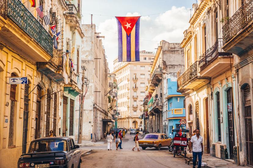 December 2015: A Cuban flag hangs over a busy street in Central Havana.