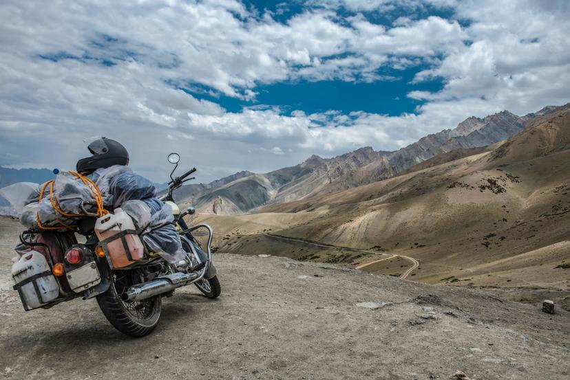 A heavily loaded motorbike in the arid high-altitude mountains around Leh.
