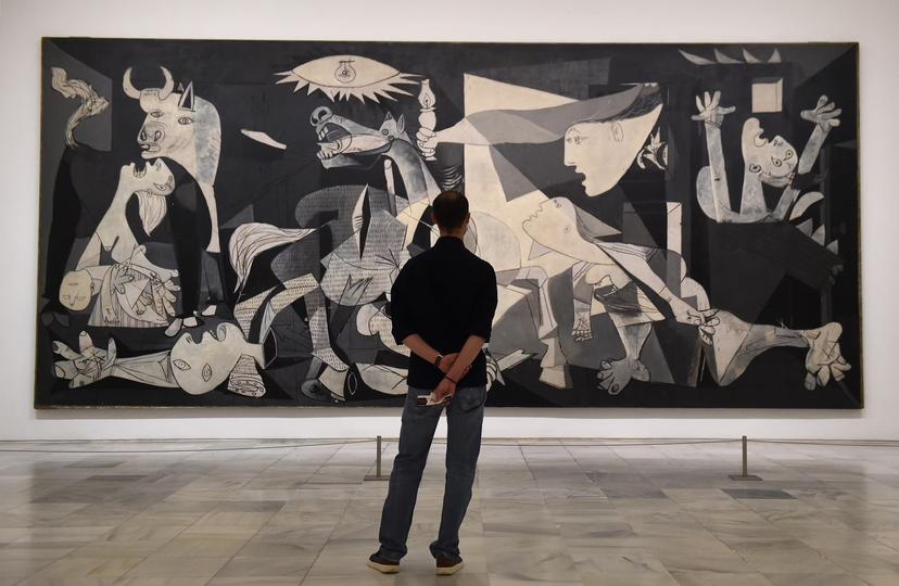 MADRID, SPAIN - JUNE 06: A man looks at Guernica by Pablo Picasso during the partial reopening of the Reina Sofia Museum, after its closure in March due to the Covid-19 pandemic, on June 06, 2020 in Madrid, Spain. A maximum of 30 people (30%) at a time are now allowed to view Picasso's iconic anti-war painting depicting the 1937 bombing of the Basque town of Guernica during the Spanish civil war.   (Photo by Denis Doyle/Getty Images)
