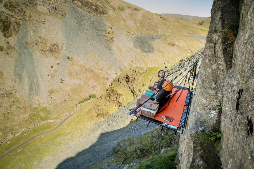 Guests abseil down a cliff face to sleep on a porta-ledge © Honister