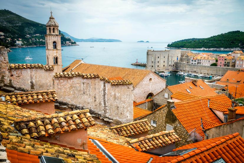 View of the Adriatic Sea from the tiled rooftops of the old town in Dubrovnik, Croatia.