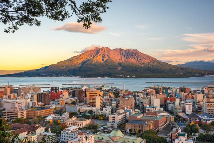 Kagoshima, Japan skyline with Sakurajima Volcano at dusk.; Shutterstock ID 1885855639; Your name (First / Last): Ben N Buckner; GL account no.: 65050; Netsuite department name: Online Editorial; Full Product or Project name including edition: Kyushu Fire Water