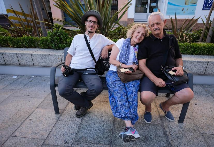 Marco Ferrarese (left) with his mother Tundra and his father Maurizio on a bench in Andalusia, Spain © Kit Yeng Chan