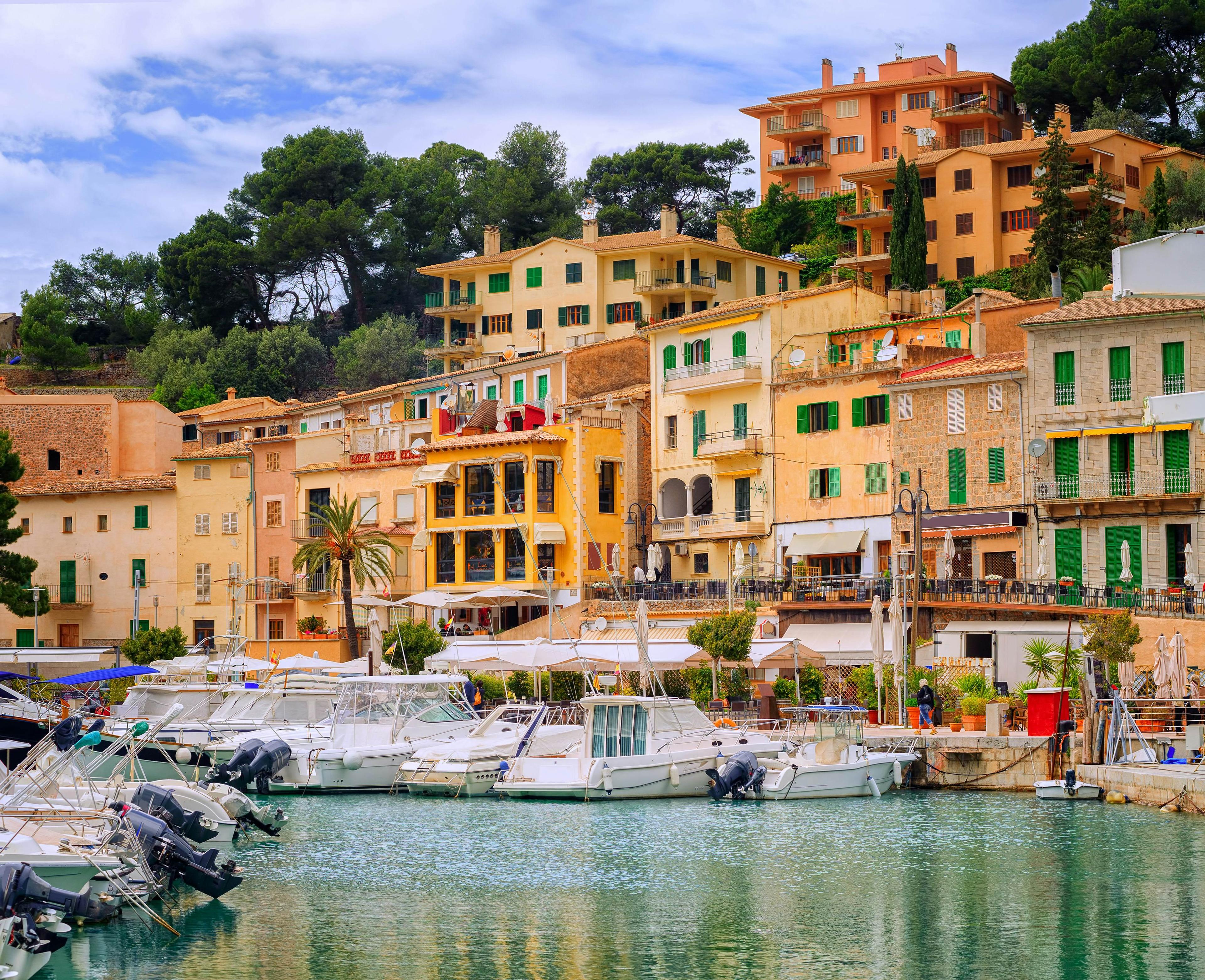 Motor boats and traditional waterside houses in Puerto Soller, Mallorca, Spain.