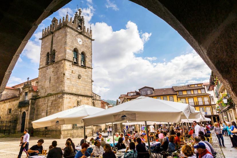 October 5, 2014: Guimarães city square, with visitors seated in outdoor restaurants.