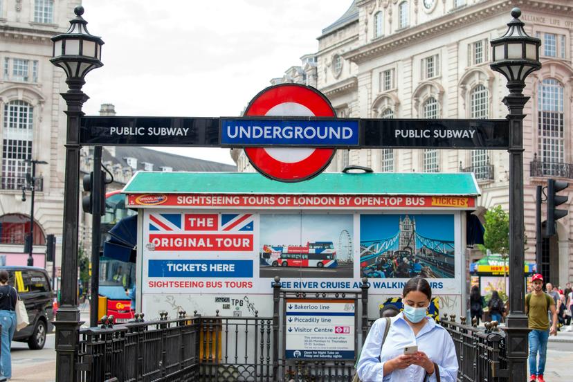 LONDON, UNITED KINGDOM - 2021/07/13: A woman leaves Piccadilly Circus underground station wearing a face mask..The mandatory wearing of Face masks on public transport in England is to end on the 19th July dubber freedom day after Boris Johnson confirmed that most mandatory Covid-19 restrictions will end. (Photo by Dave Rushen/SOPA Images/LightRocket via Getty Images)