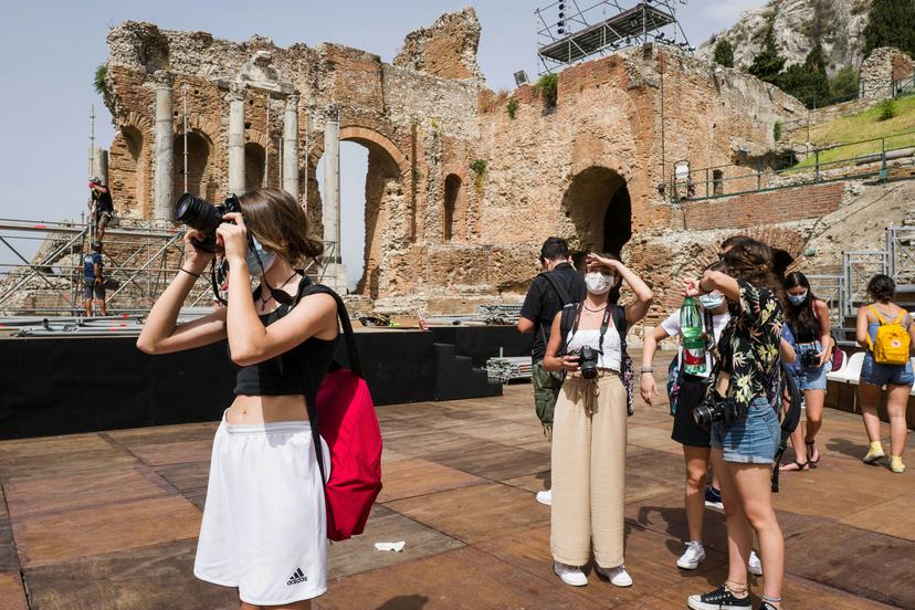 TAORMINA, ITALY - JUNE 22: Students from Catania's Nicola Spedalieri High School visiting the Teatro Antico in Taormina while taking photographs on June 22, 2021 in Taormina, Italy. Tourists return to the hill-top town of Taormina near Mount Etna after Covid-19 restrictions have been lifted. (Photo by Fabrizio Villa/Getty Images)