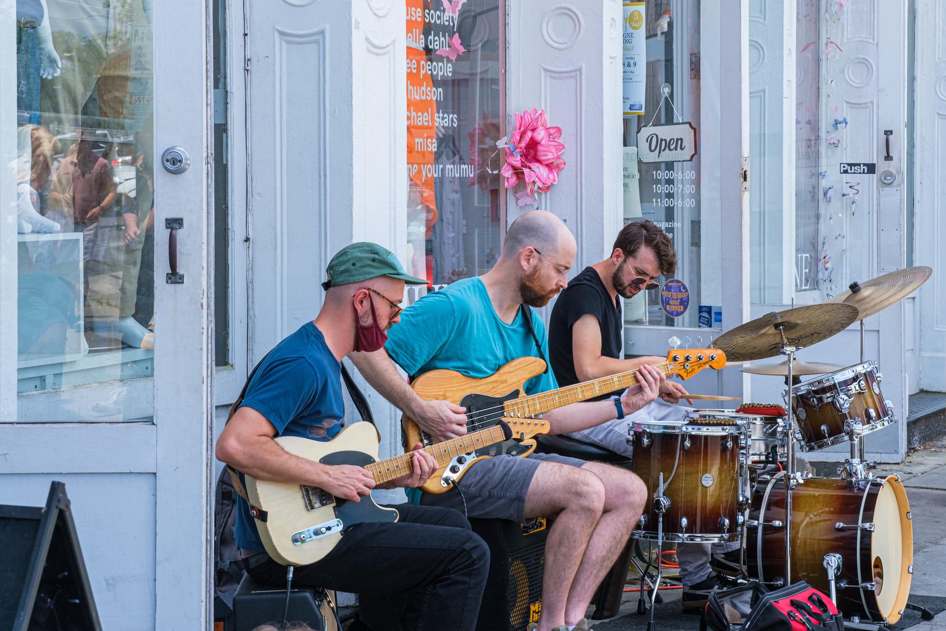 Musicians playing in front of shop on Magazine Street