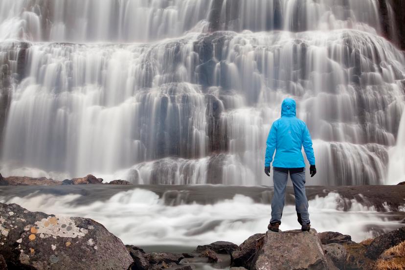 Hiker in front of the Dynjandi waterfall, Westfjords