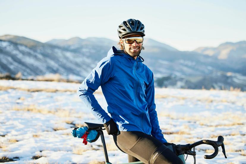 A cyclist pauses on a snowy track in Colorado