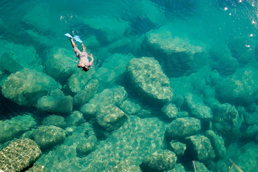 A snorkeler explores the scenic rock formations of the islands of Lake Malawi, Malawi, Africa.; Shutterstock ID 151133624; your: Claire Naylor; gl: 65050; netsuite: Online editorial; full: Malawi national parks