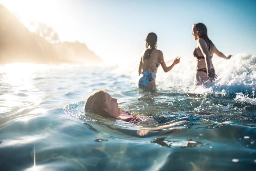 Friends swimming in the ocean in summer in Australia