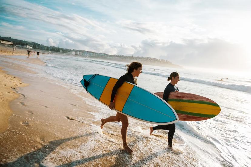 Surfing is a way of living in Australia and young and mature sporty women go surfing every morning.