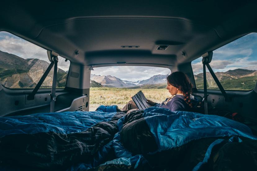 A woman camping in a van in Alaska
