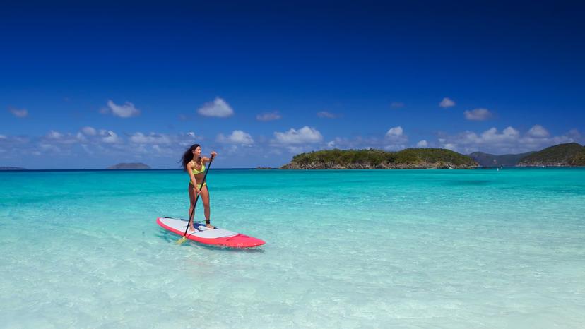 young attractive multi-ethnic woman on paddle board at cinnamon bay, United States Virgin Islands
