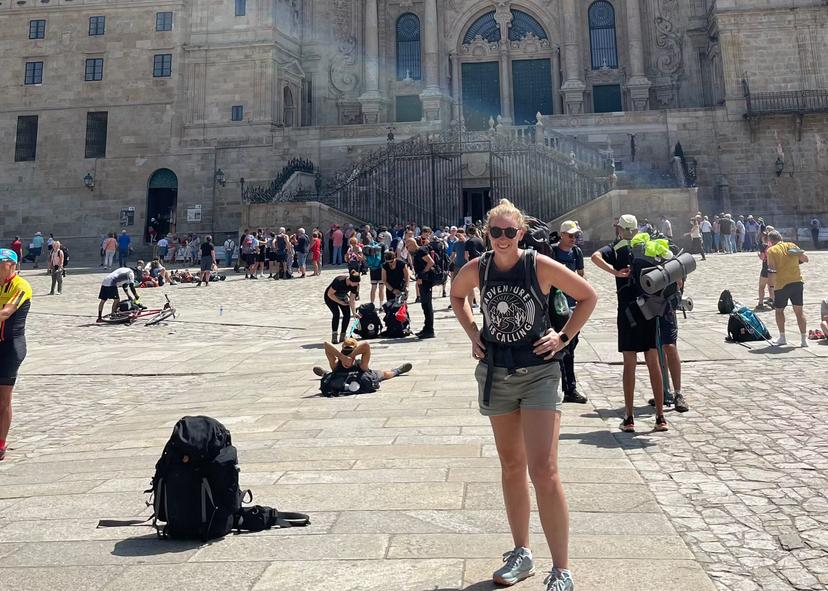 Lonely Planet senior news editor Melissa Yeager at the Cathedral in Santiago de Compostela after finishing the Portuguese Way of the pilgrimage. 