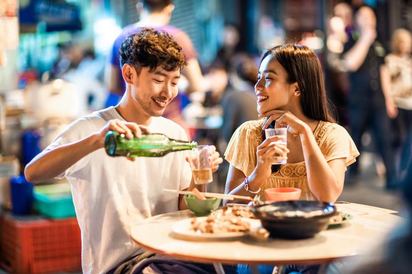 Asian couple enjoying street food in Hong Kong