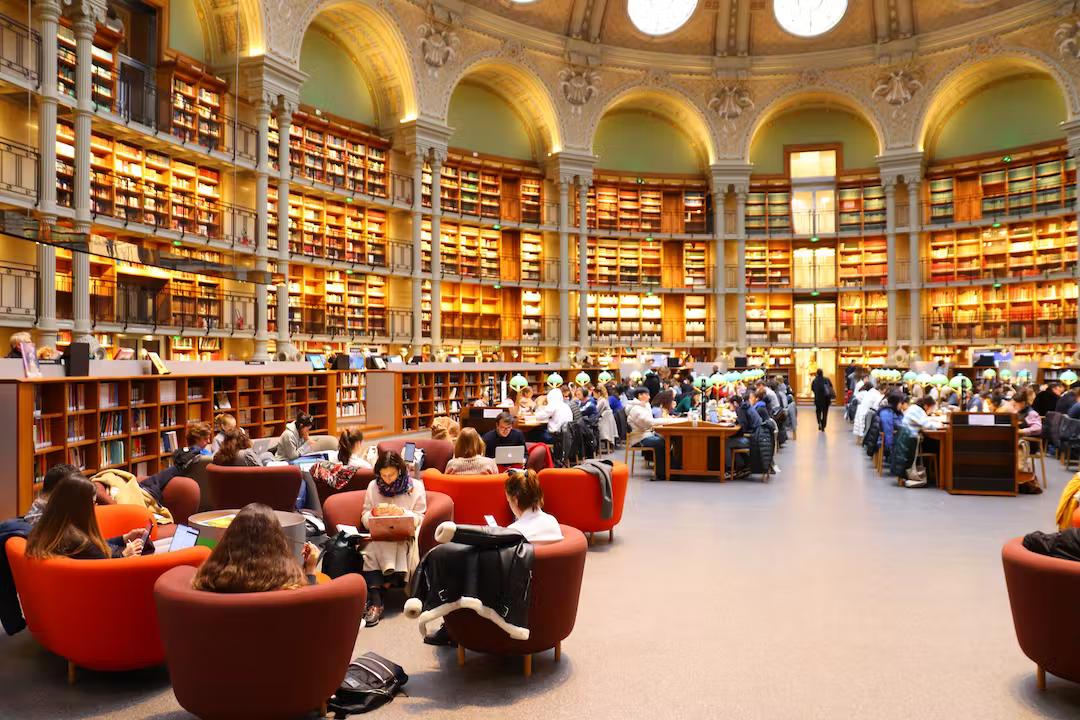 Readers in the Salle Ovale at the Richelieu site of the Bibliothèque Nationale de France, Paris