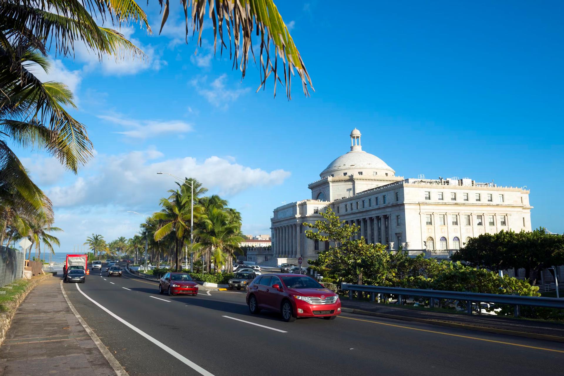 Cars travel past the Capitol Building (El Capitolio) in San Juan, Puerto Rico.