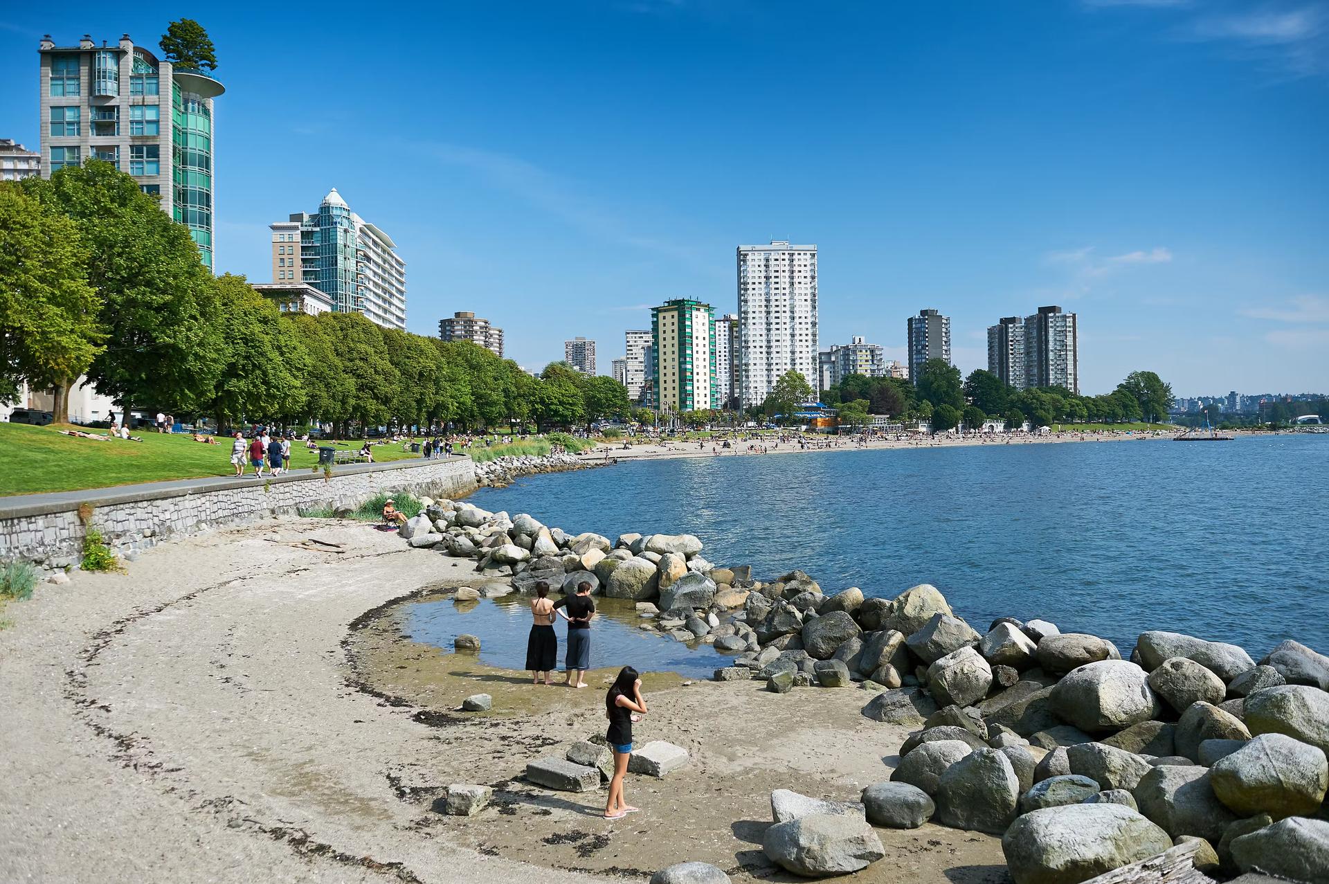 Panoramic view at English Bay with beach and people in West End, near Morton and Stanley Park