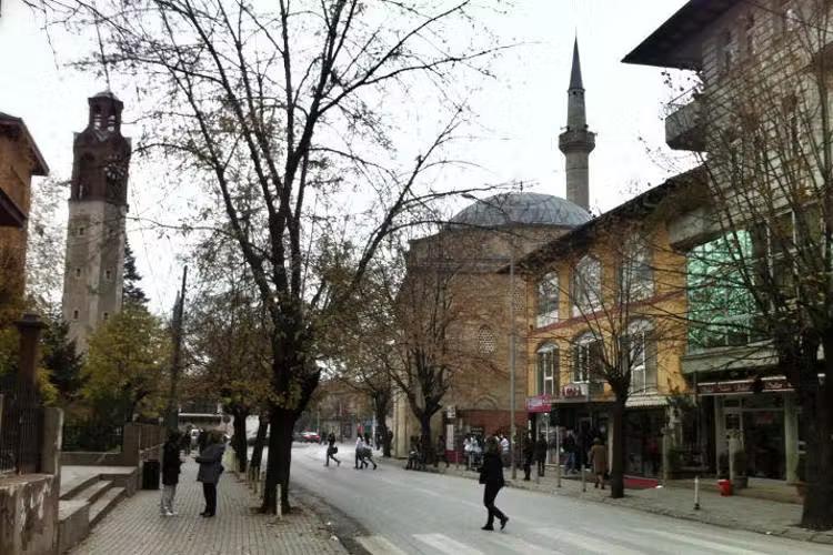 The clock tower and a mosque in Pristina's old quarter. Image by Larissa Olenicoff / Lonely Planet