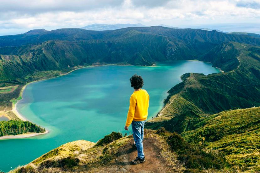 Azores Islands, San Miguel, Man looking at the Lake of Fire, seen from behind.