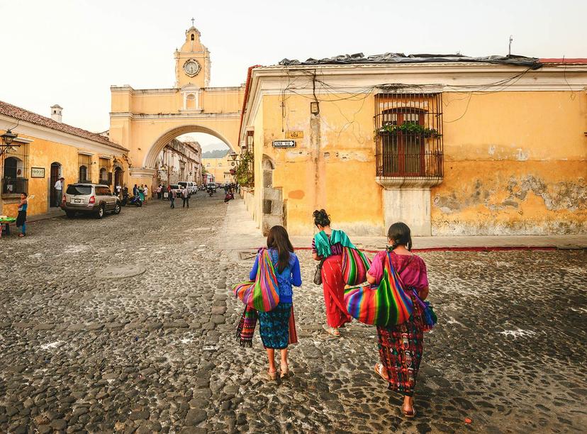 Women walk through Antigua's iconic streets © John Crux Photography / Lonely Planet
