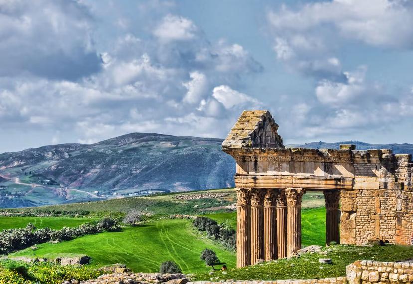 The archaeological site of Thugga/Dougga is located in the North-west region of Tunisia, perched on the summit of a hill at an altitude of 571 m, dominating the fertile valley of Oued Khalled. The impressive ruins give an idea of the resources of a Romanised Numidian town.