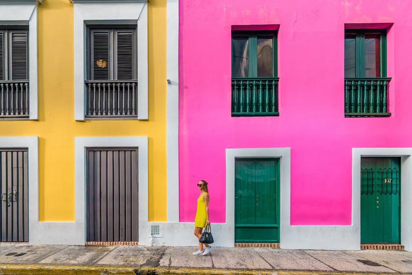 Woman in a yellow dress in front of Colourful facades in Old San Juan, Puerto Rico 