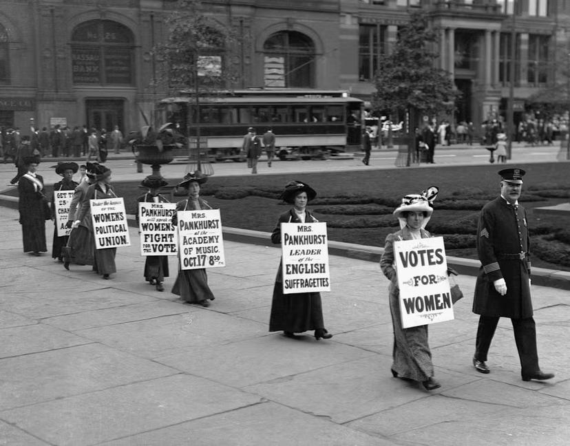   Suffragettes parade down Bedford Avenue in Brooklyn wearing signs reading "Votes for Women"