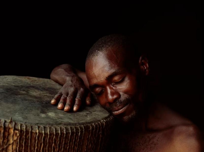 A Batwa drummer happily lost in his dreams © Harry Hook / Getty Images