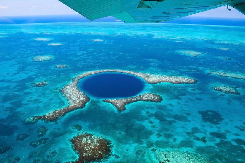 Plunging into the Light House Reef is the Blue Hole, a national monument (and heralded dive site) in Belize © Emma Shaw / Lonely Planet