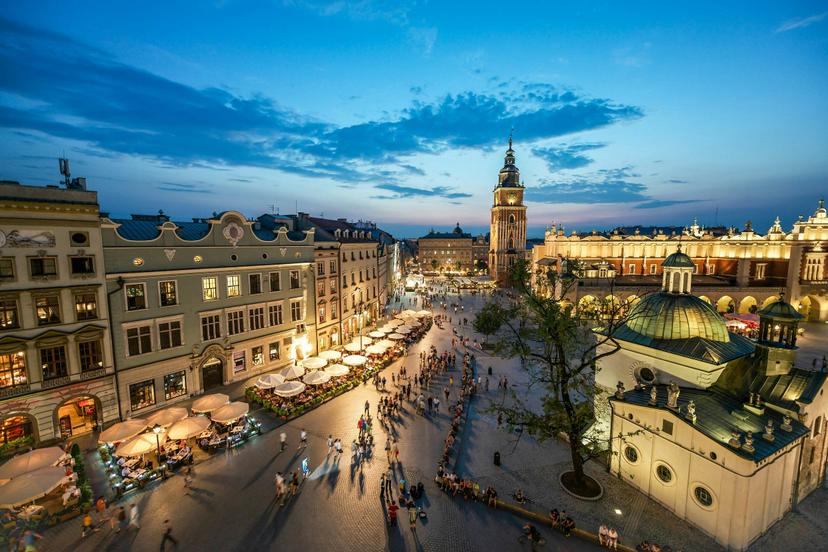 People strolling through Kraków’s Main Market Square in the evening © Capture / Getty Images
